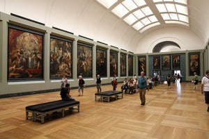 A sunlit gallery inside the Louvre museum.