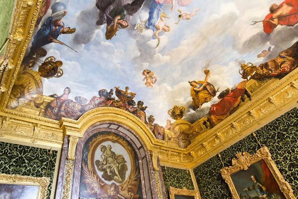 The ornate ceiling of a room at the Palace of Versailles.