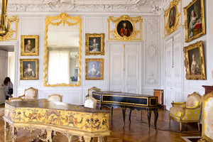 A salon with classical instruments inside Versailles.