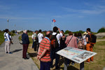 Load image into Gallery viewer, Tourists listen to a guide at the Juno Beach Centre.
