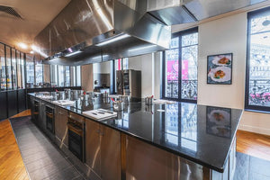 Individual cooking stations face a Paris street view.