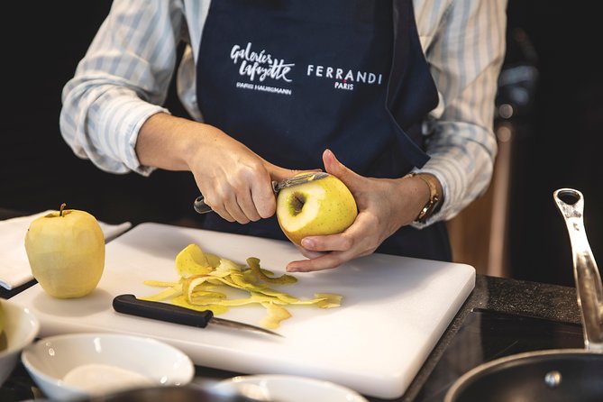 A Ferrandi chef peels a Golden apple.