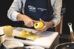 Load image into Gallery viewer, A Ferrandi chef peels a Golden apple.
