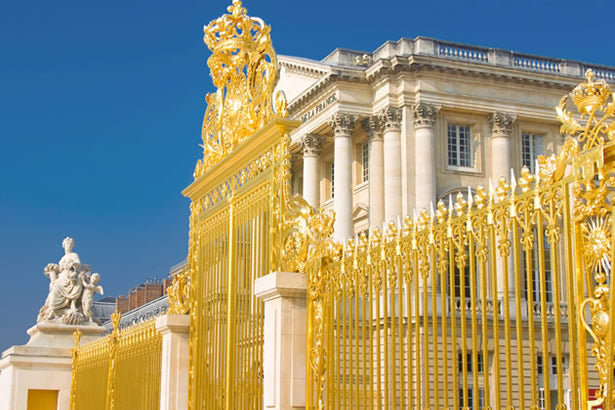 The golden gates outside of the Palace of Versailles.